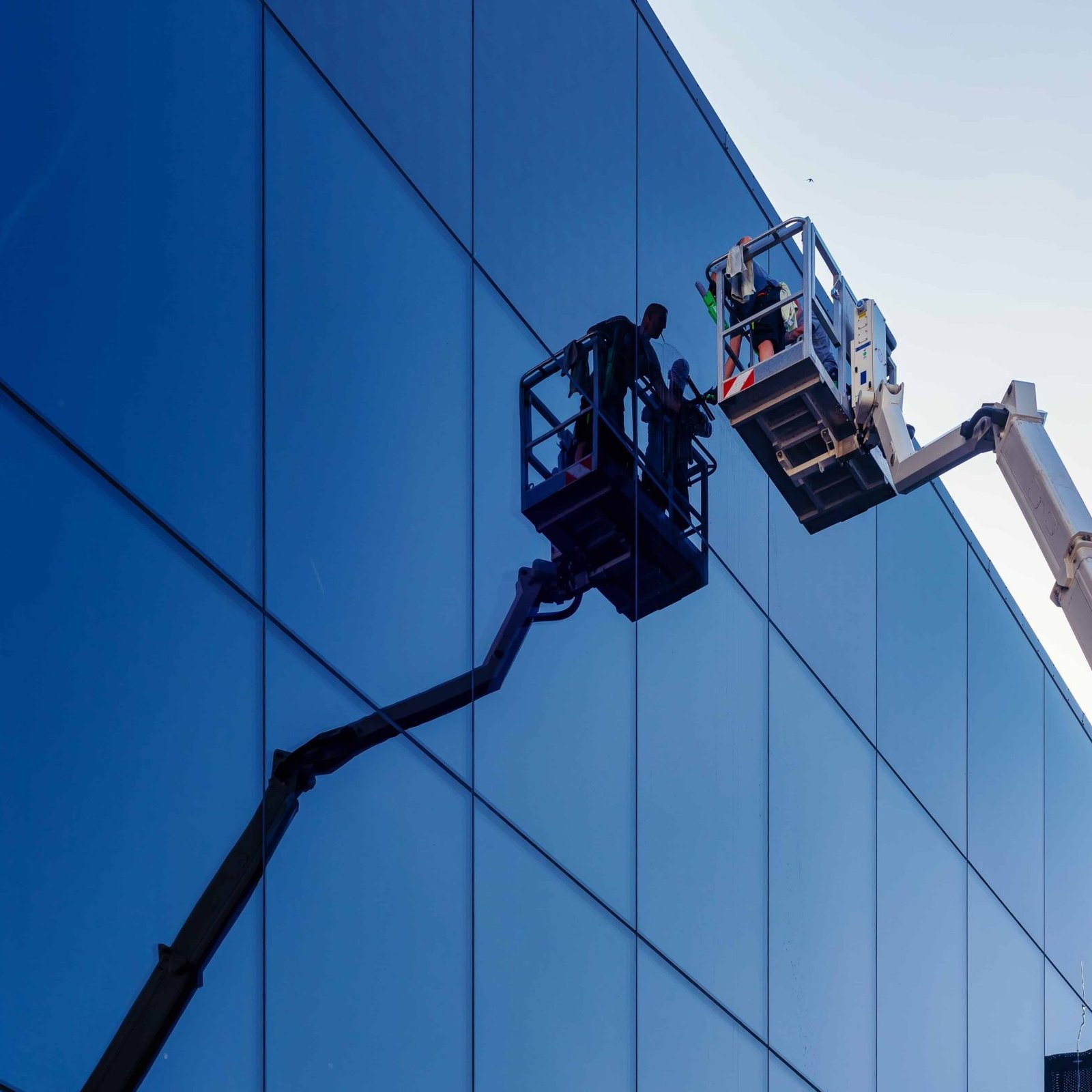 Worker on a glass facade - Bristol Pressure Washing (Bristol Render Cleaning)