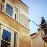 A man cleaning high windows - Bristol Pressure Washing